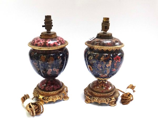 A pair of pottery and brass mounted table lamps, late 19th century, probably Zsolney Pecs, of quadralobe form on a pierced base and shaped feet, 27cm