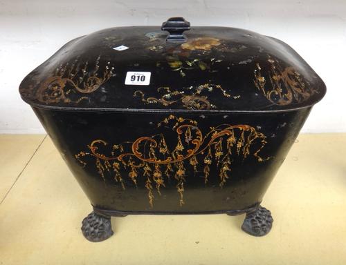 A Regency tole piente coal purdonium, gilt foliate decorated against a black lacquered ground, with lion ring handles and lions paw feet, 45cm wide.