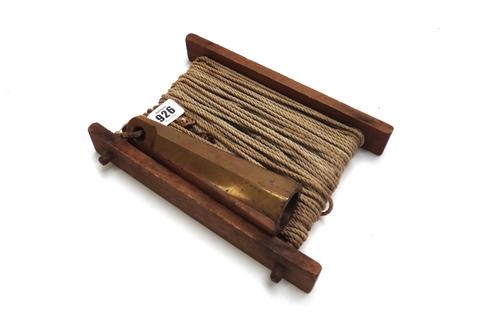 An unusual bronze 3.5lb sea fishing weight and line, circa 1900, stamped 'S. W. Carr, Pine Bluff, 1907, Lake Cobbosseecontee Maine', the weight 18cm.