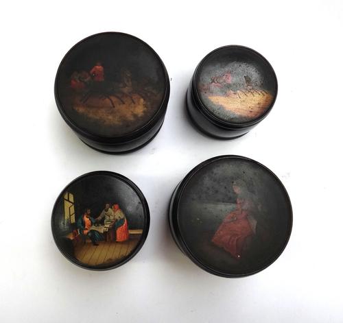 Two Russian papier mache lidded pots, 19th century, one decorated with a typical troika scene, the other with a seated lady, 13cm diameter, together w