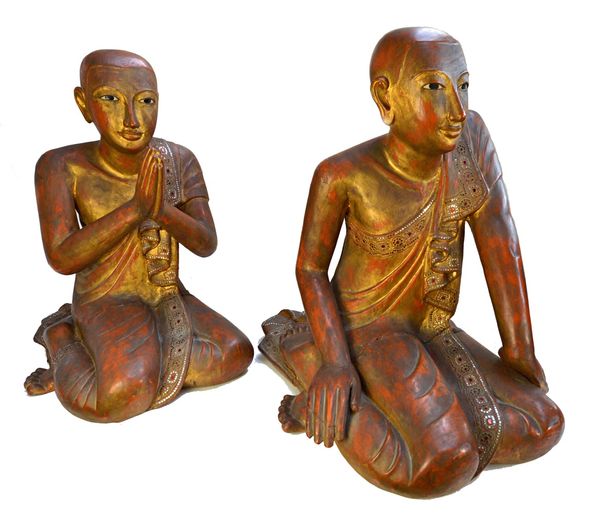 A pair of modern giltwood carved figures, each depicting a South East Asian buddhistic figure in a contemplative pose, decorated with inset coloured g