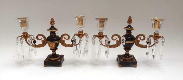 A pair of Regency gilt bronze and cut glass twin branch candelabra, 19th century, of urn form with foliate cast sconces and cut glass drops, 22cm high