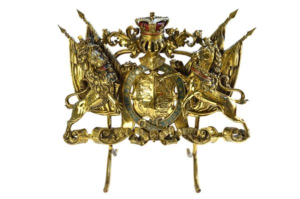 An English gilt brass fire screen, late 19th/early 20th century, modelled and cast as the royal coat of arms, on a shaped metal frame, 75cm wide, and