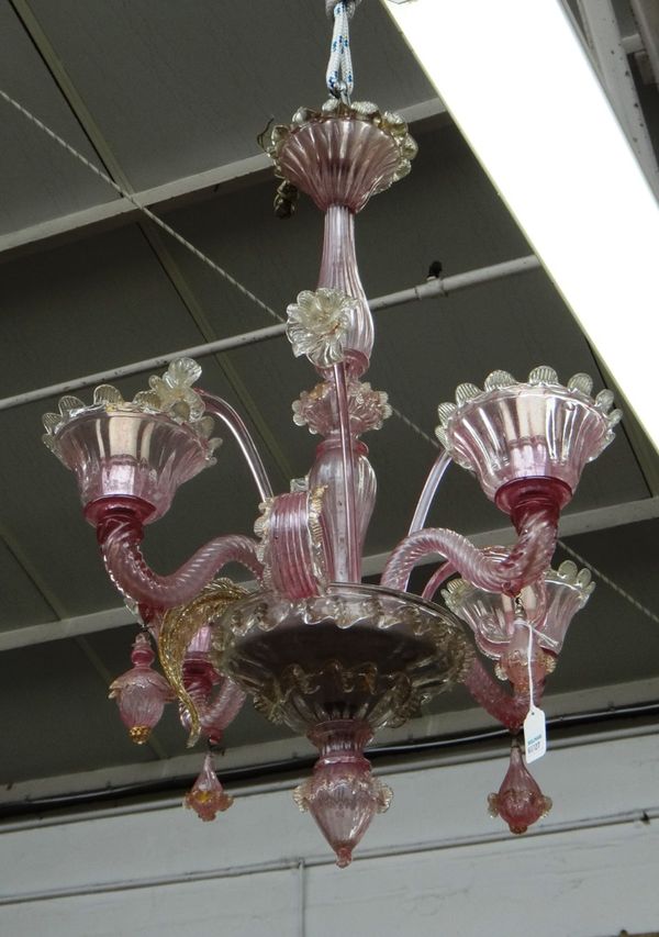 A Victorian cranberry glass chandelier, the baluster stem issuing four spiral twist branches interspersed with glass flowers and leaves with frilled f