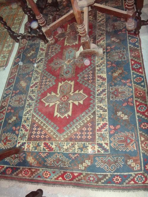 A modern Belouch rug in blues and purples, with three star medallions.