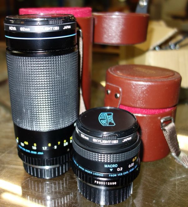 A Carl Zeiss cased camera lens, and another smaller. (2)