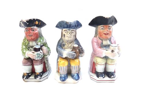 A Pratt type Toby jug, circa 1810, of typical form, 23.5cm high, and two further Staffordshire Toby jugs (a.f). (3)