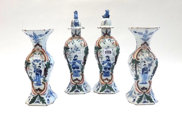 A garniture of Dutch Delft vases and covers, late 19th century, of baluster form, each decorated with Oriental figures, and a matching pair of vases,
