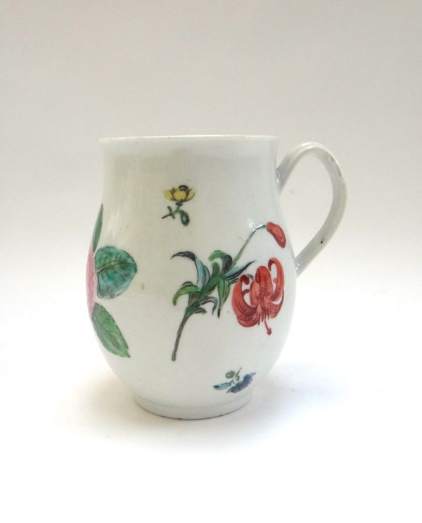 A Worcester porcelain polychrome mug, circa 1770, with ribbed handle and painted with flower sprays and sprigs (a.f), 12.5cm.high.