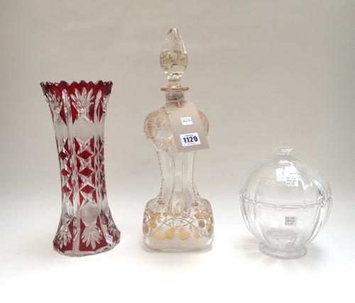 A Venini style clear glass decanter and stopper, early 20th century, of pinched waist form, gilt engraved with fruiting vines, 39cm high, together wit