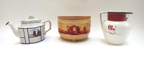 A Castleford type white feldspathic stoneware teapot and cover, circa 1810, moulded with leaves, one side painted with a sailing vessel off the coast