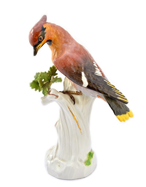 A Meissen porcelain figure of a waxwing, early 20th century, modelled atop a naturalistic tree stump, with blue crossed swords and incised marks (a.f)