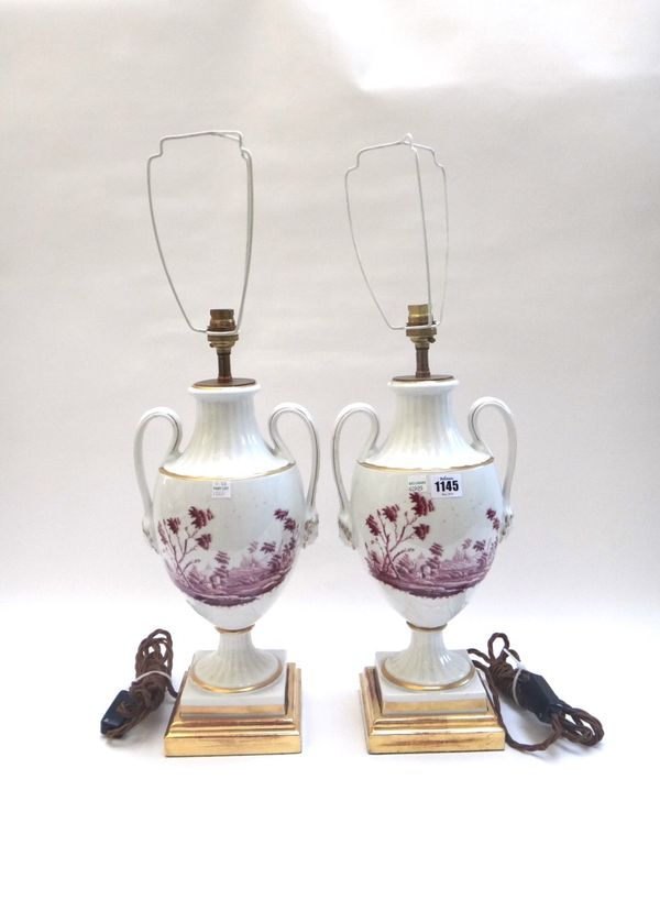 A pair of two handled porcelain vases adapted as lamps, 20th century, each painted in puce with an Italianate landscape, on a square giltwood plinth,