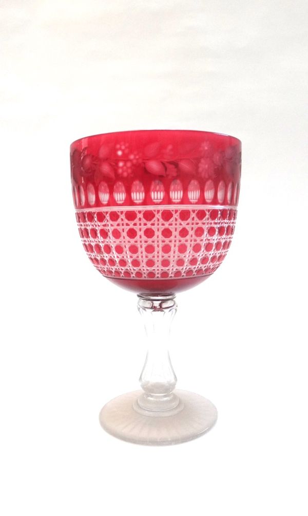A Victorian cranberry cut glass pedestal vase, with rose engraved border, faceted stem and a star cut foot, 32.5cm high.