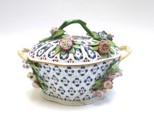 A Worcester porcelain basket and pierced cover, circa 1765, possibly painted in the workshop of James Giles, of shaped oval form, set with flowering b