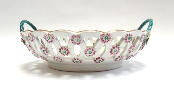 A Worcester porcelain two handled basket, circa 1770, painted with flowers, with pierced rim and applied foliate decoration, 21cm wide across the hand