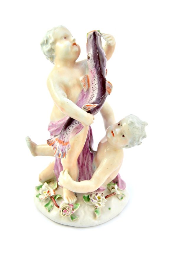 A rare Vauxhall porcelain group of two putti and a dolphin, circa 1755-58, both putti draped in a puce wrap, one standing with arms around the fish, t