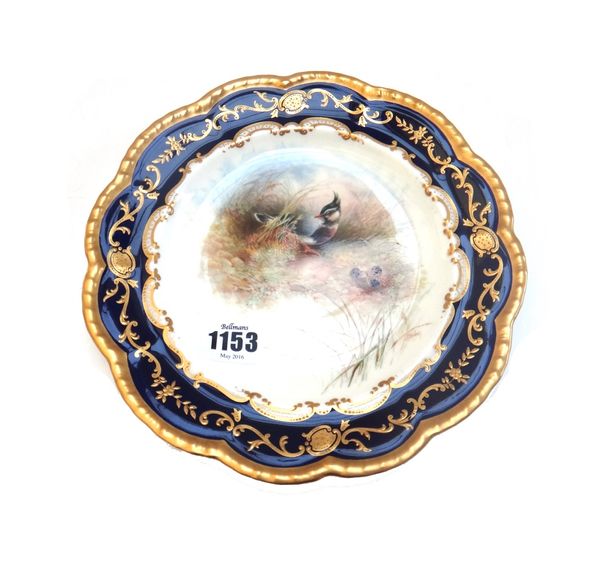 A Cauldon bone china plate, early 20th century, painted by J.Birbeck, signed, with a titled Plover inside a deep blue and gilt border, printed factory