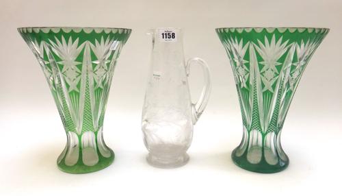 A quantity of glass wares, including; a foliate engraved glass jug, 26.5cm high, two cut glass ships decanters, a large Victorian cut glass pedestal v