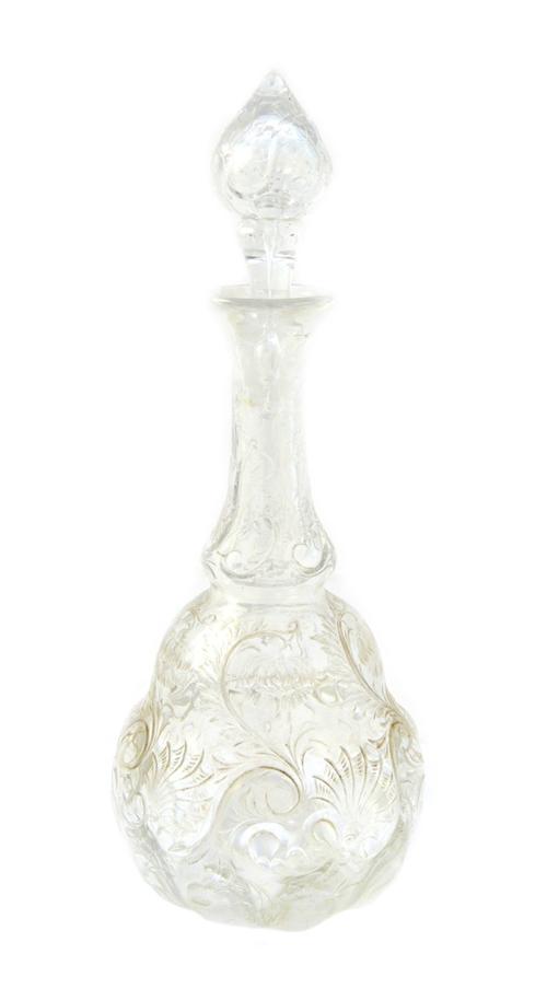 A 'rock crystal' glass decanter and stopper, circa 1890, possibly by Webb or Stevens & Williams, finely engraved with trailing flowers against a shape