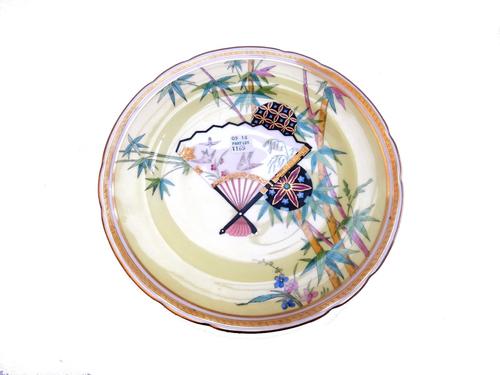 A Mintons Aesthetic period part dessert service, circa 1876, with yellow ground decorated in the Oriental taste, comprising; a footed comport and six