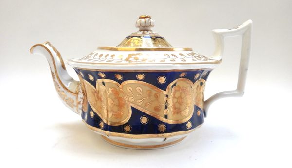 A group of Ridgway porcelain teawares, circa 1825, in three patterns, with gilt flowers against a deep blue ground, comprising; three teapots and cove