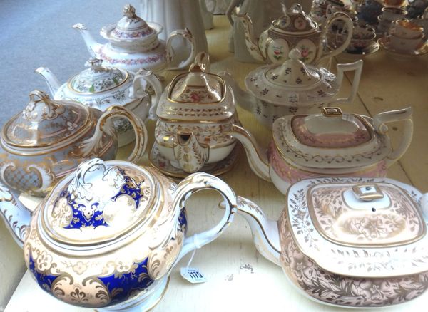 A group of nine English porcelain teapots and covers and two teapot stands, mostly Ridgway, 19th century, various forms and decoration, (a.f).