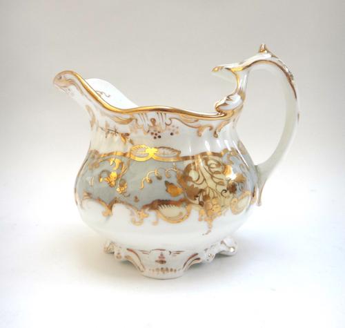 A group of eleven English porcelain milk jugs, mostly Ridgway, 19th century, various forms and decoration, one with matching cup, saucer and side plat