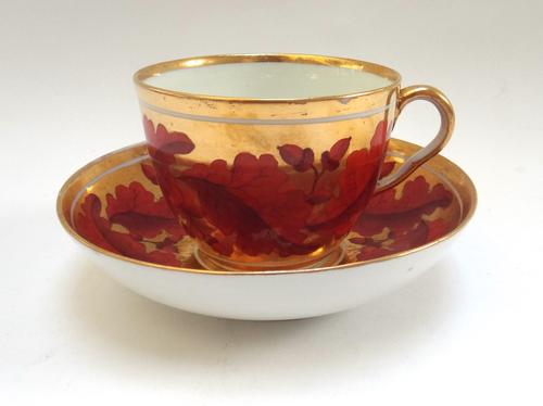 A group of eleven English porcelain cups and saucers, early 19th century, including a Derby bute shaped example painted with acorns and leaves on a so