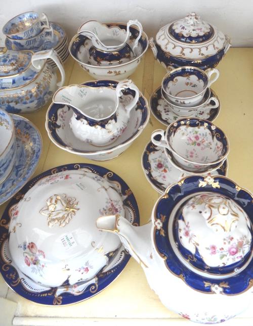 A group of Ridgway teawares, circa 1840, in three patterns, each piece painted or printed and coloured with flowers against a deep blue ground, compri