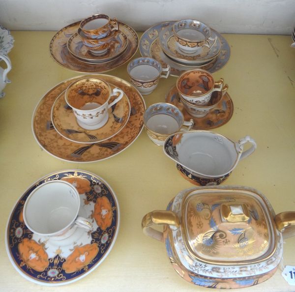 A group of Ridgway porcelain tea and coffee wares, circa 1820, in three patterns, each with rich foliate decoration on a salmon pink or blue ground, c
