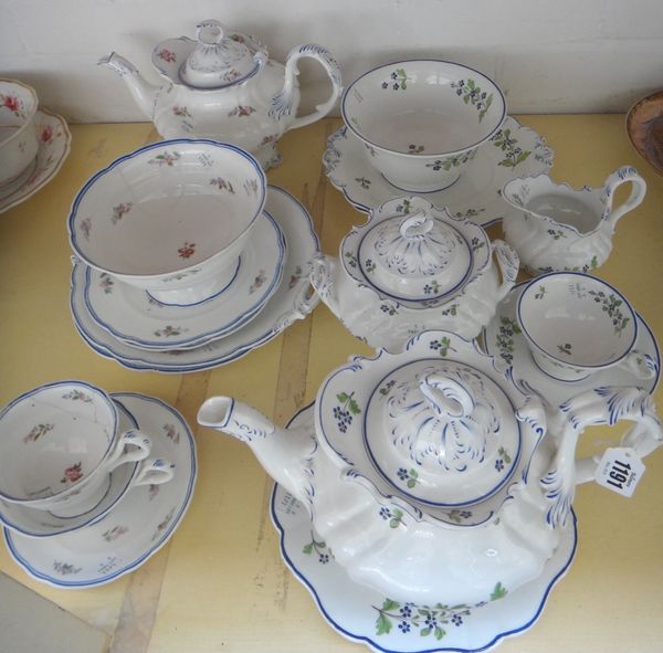 A Ridgway composite rococo moulded part tea service, 1840's, painted with scattered cornflowers, comprising; a teapot, cover and a stand, sucrier and