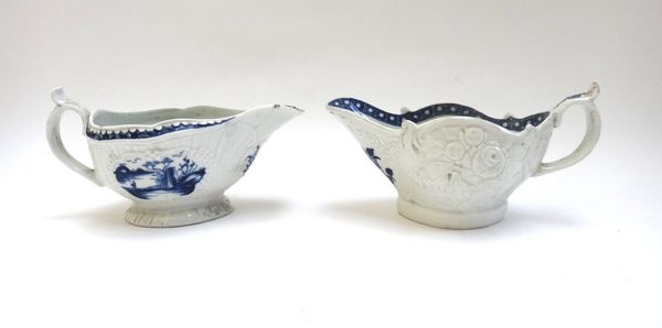 Two Worcester blue and white sauceboats, circa 1765, the first painted with the `Fisherman and Billboard Island' pattern, the second with flower mould