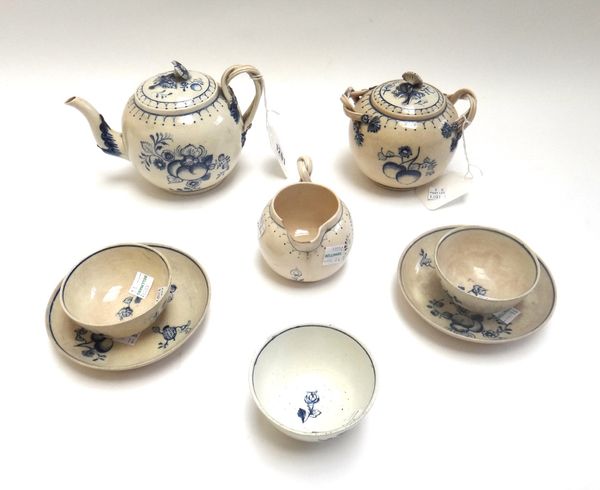 An earthenware blue and white part tea service, in 18th century creamware style, each piece painted with fruit, comprising; teapot and cover, sucrier