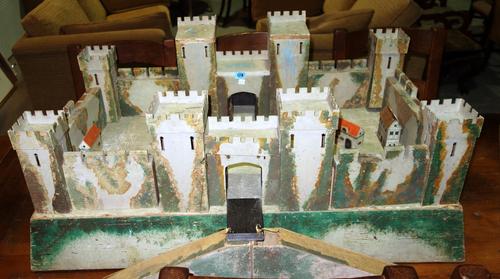 A child's painted wooden model fort.