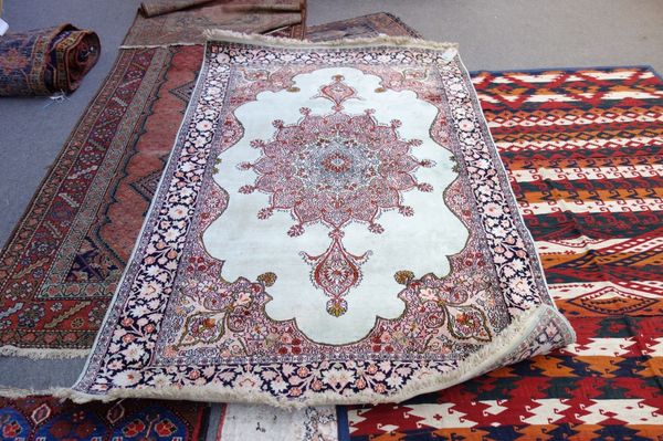 An Indian silk rug.