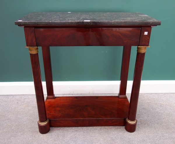 An Empire gilt metal mounted console, the black marble top over flush fit frieze drawer, on a pair of turned columns, united by platform undertier, 82