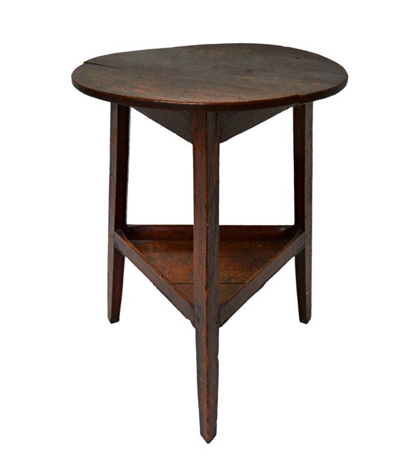 A George III oak cricket table, the circular top on three splayed supports, united by galleried triangular undertier, 55cm wide. Illustrated