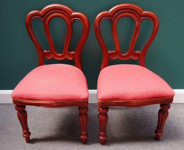 A set of ten Victorian style mahogany dining chairs, with triple arch back and serpentine seat on baluster reeded supports, (10).