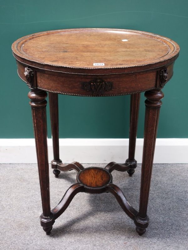 A Louis XVI style gilt metal mounted oak occasional table, the circular top on four tapering octagonal supports, united by platform undertier, 59cm wi