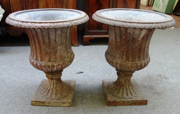 A pair of lead lined cast iron jardinieres with fully fluted bodies and soccles on square base, 42cm wide x 50cm high, (2).