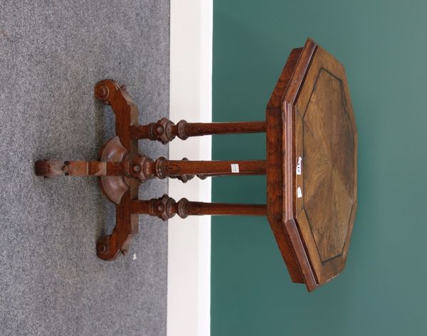 A Victorian oak occasional table, the stella veneered octagonal top on four turned columns and four downswept supports, 50cm wide.