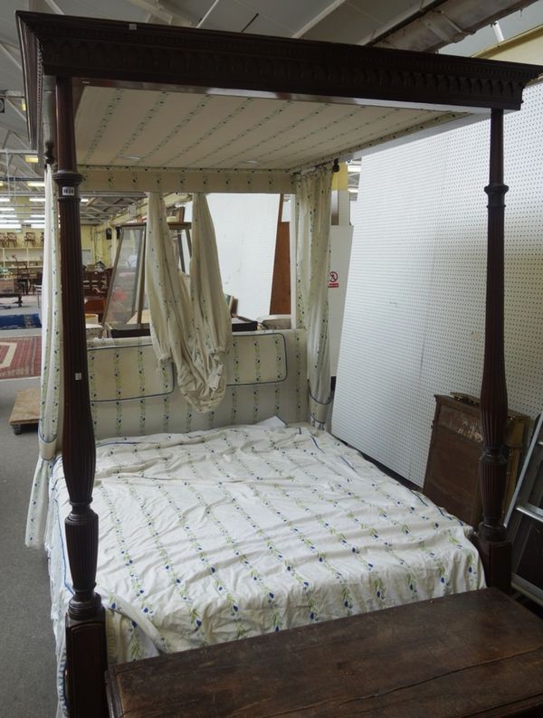 A 19th century mahogany four poster bed, the canopy with dental and pendant moulded frieze, the footboard with reeded baluster supports, 165cm wide x