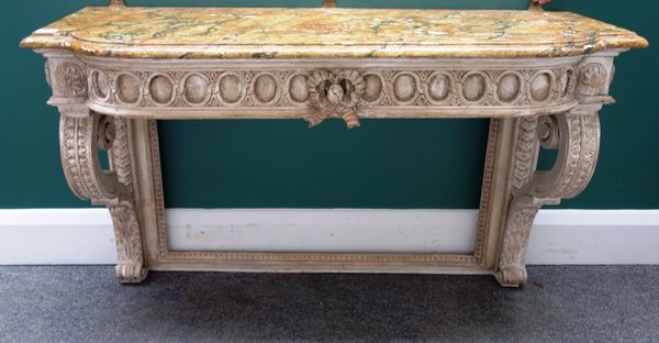 A 19th century console table, the faux painted marble top over a carved cream painted base, on a pair of scroll supports, 103cm wide.