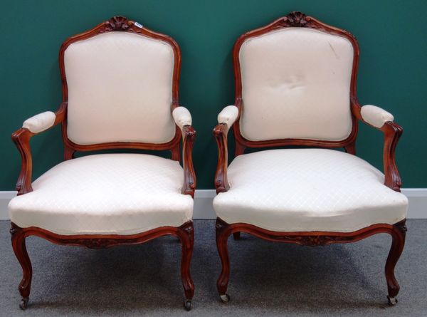 A set of four Louis XV style stained beech fauteuils, with shell carved crests and serpentine seats, on cabriole supports, (4).