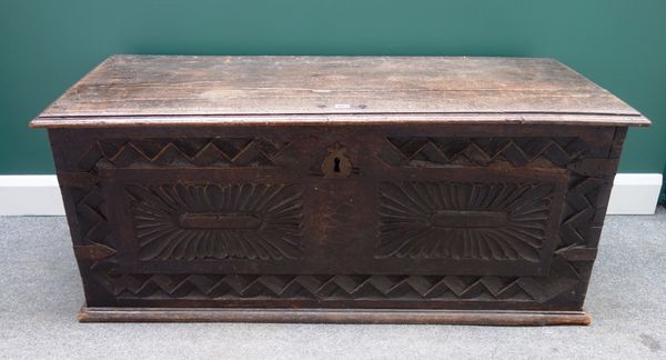 A late 17th century Continental walnut coffer, with carved front, 136cm wide.