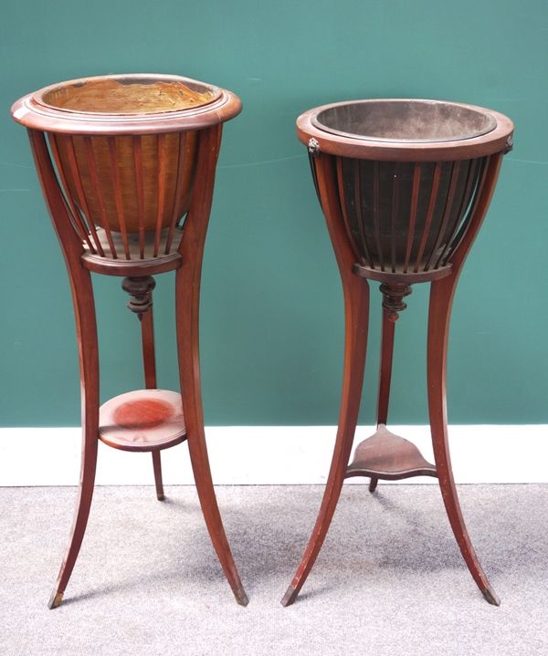 An early 20th century mahogany framed jardiniere with open slatted body and three sabre supports, together with another similar, (2).