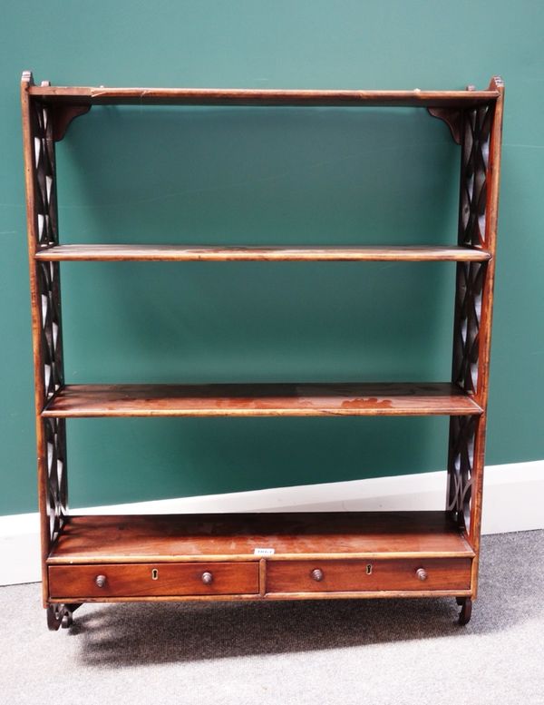 A George III mahogany four tier wall shelf, with pierced fret cut sides, the lower tier with a pair of drawers, 72cm wide.