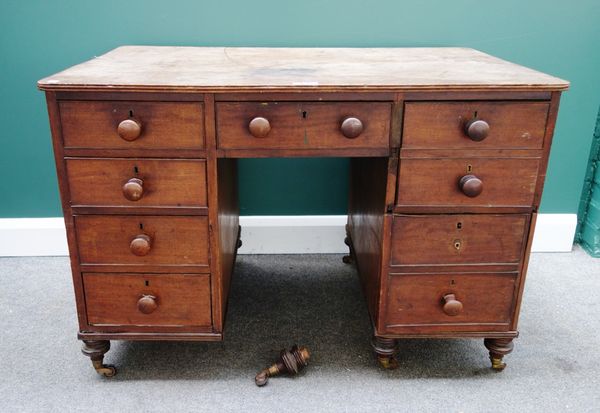 A 19th century mahogany writing desk, with an arrangement of drawers and cupboards about the knee, 109cm wide.