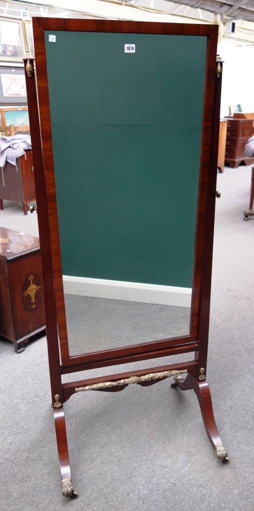 A 19th century gilt metal mounted mahogany cheval mirror, with rectangular plate on four downswept supports, 70cm wide.